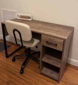 a wooden desk with a white chair and a drawer at Bright 2BR and1BA Home Near Old Town, Metro, Airport and Potomac Yard in Alexandria