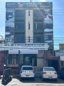 due auto parcheggiate in un parcheggio di fronte a un hotel di Caribe Palace Hotel Taguatinga a Brasilia