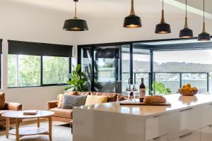 a kitchen and living room with a couch and a table at Driftaway, Albany in Albany