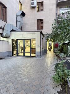 a building with a lot of glass doors on it at Mali Home in Yerevan
