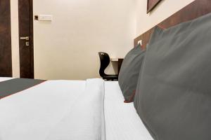 a bedroom with a bed and a desk with a chair at Collection O Royce Studios Near Pune Airport in Pune +25 photos
