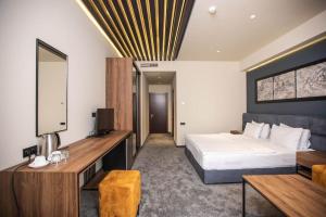 a hotel room with a bed and a television at Mali Home in Yerevan +14 photos