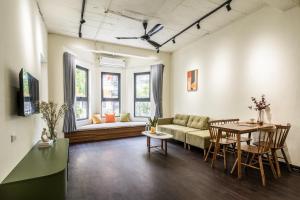 a living room with a couch and a table at Sweet Home in Hanoi