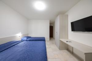 Un dormitorio con dos camas y un televisor de pantalla plana. en M9 Rest House Venice, en Venecia