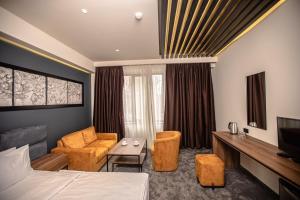 a hotel room with a bed and a living room at Mali Home in Yerevan