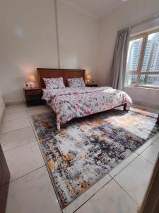 a bedroom with a bed and a rug at Delightful Private Rooms with Garden View in Sharjah