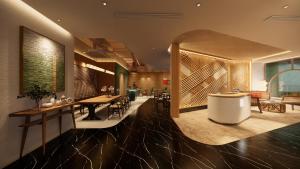 a lobby with tables and chairs in a building at NiK Hotel Nguyen Trai in Ho Chi Minh City