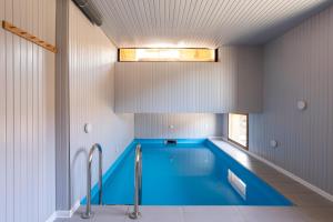 a swimming pool in a house with a ceiling at Chalet La Tanière 14 Pers - piscine chauffée et sauna - Vars Saint Marcellin in Vars +87 photos