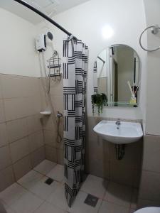 a bathroom with a shower and a sink at camella northpoint condominium close to airport,sm lanang,abreeza mall,spmc,dmsf,usep in Davao City +9 photos