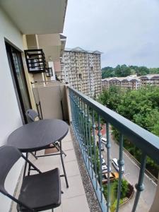 a balcony with a table and chairs on a building at camella northpoint condominium close to airport,sm lanang,abreeza mall,spmc,dmsf,usep in Davao City