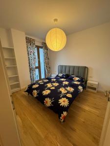 a bedroom with a bed with a black and white comforter at Central monarch 1 P&P Residence in Timişoara