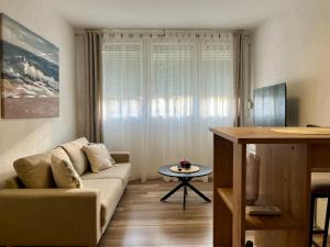 a living room with a couch and a table at Apartman Nota in Vinkovci