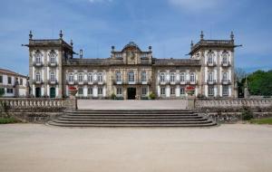 a large building with stairs in front of it at Alojamento 444 in Monção