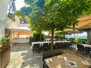 a restaurant with tables and chairs and a tree at Gasthaus Wollscheid in Trier