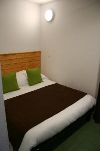 a bedroom with a large bed with green pillows at Adrechas Mercantour in La Colmiane +65 photos