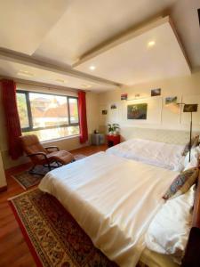 a bedroom with a large white bed and a window at SaPa Global Hotel in Sapa
