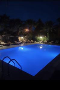 a large blue swimming pool at night at Eldorado Hotel in Kumluca