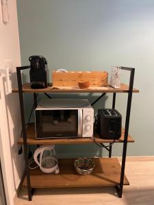 a microwave sitting on a shelf with a microwave at Appartamento Cielo e Mare in Pietra Ligure +5 photos