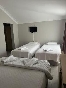 a hotel room with two beds with towels on them at Eldorado Hotel in Kumluca +8 photos