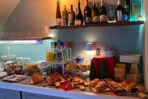 a counter with a bunch of food and drinks on it at La terrazza nel borgo in Tortora +54 photos