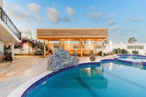 a swimming pool with a gazebo and a swimming pool at Villa Fika in Dar es Salaam +39 photos