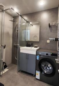 a bathroom with a washing machine and a sink at CozyNest Apartment In Yerevan, Center in Yerevan