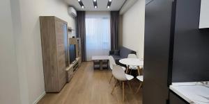 a room with a table and chairs and a kitchen at CozyNest Apartment In Yerevan, Center in Yerevan