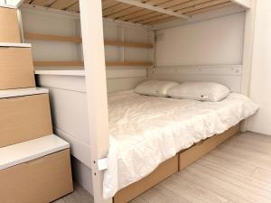 a bedroom with a bunk bed and shelves at You Rou De Di Fang in Huxi