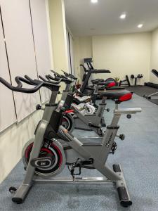 a row of exercise bikes in a gym at Aqua Horizon Art Studio Condo in Dauis