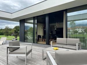 a house with a patio with chairs and a table at Rosso di sera in Thiene +5 photos