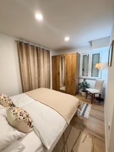 a bedroom with two beds and a table and a chair at RELAXING Apartments LUCE in Čilipi +36 photos