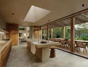 a kitchen and dining room with a table and chairs at Casa Xul in Tulum