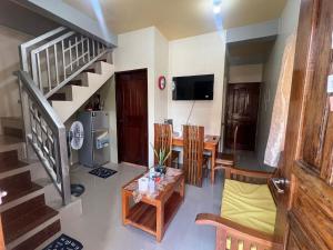 a living room with a table and a dining room at Westlinehomestay in Puerto Princesa City