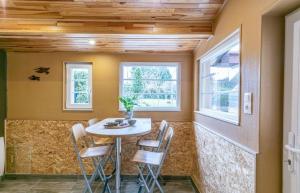a small dining room with a table and chairs at Jardin Stan in Chiny