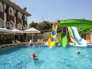 a group of people in the water at a swimming pool at FAME HOTEL in Kemer