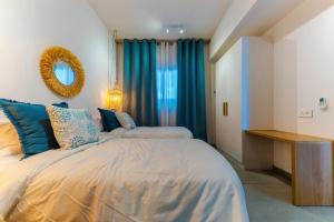 a bedroom with two beds and a mirror at Tropica Bliss in Grand-Baie +12 photos