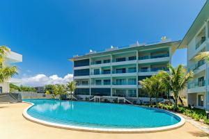 a swimming pool in front of a building at Tropica Bliss in Grand-Baie