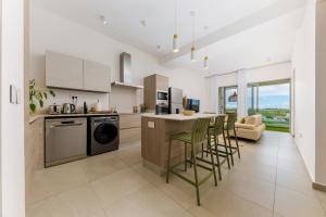 a kitchen with a table and chairs in a room at Tropica Bliss in Grand-Baie