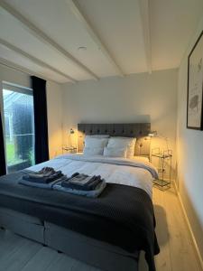 a bedroom with a large bed with towels on it at Boutique stay Mir Lo in Mierlo in Mierlo