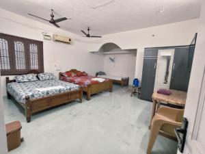 a bedroom with two beds in a room at Aala Stays in Tirunelveli +11 photos