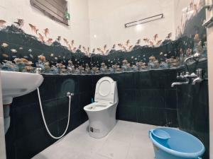 a bathroom with a toilet and a sink at Aala Stays in Tirunelveli