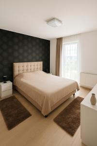 Postel nebo postele na pokoji v ubytování Lumina Park Residence by Nicolle Apartments