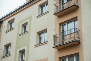a building with balconies on the side of it at Sandstone Residence - Modern Apartment - 5 min Walk to Beach in Liepāja +8 photos