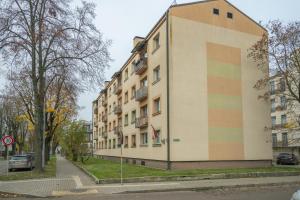 a building with a rainbow stripe on the side of it at Sandstone Residence - Modern Apartment - 5 min Walk to Beach in Liepāja