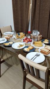 a table with plates of food on top of it at Private Rooms And Bed Spaces Available In Sohar I18 OMR For EACH Person in Al ‘Awhī