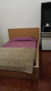 a bed with a wooden headboard next to a dresser at El sueño - Le rêve in San Bartolomé +16 photos