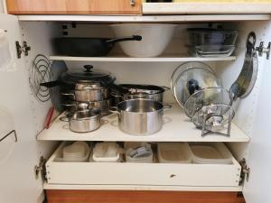 a shelf with pots and pans in a kitchen at Wolkrova city stay in Bratislava