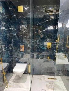 a bathroom with a toilet and a glass shower at F3 Draria équipé Alger in Draria +8 photos