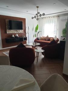 a living room with couches and a flat screen tv at F3 Draria équipé Alger in Draria