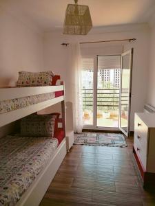 a bedroom with a bunk bed and a balcony at F3 Draria équipé Alger in Draria